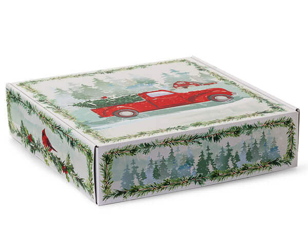 Decorative box with a red truck and greenery design on a white background