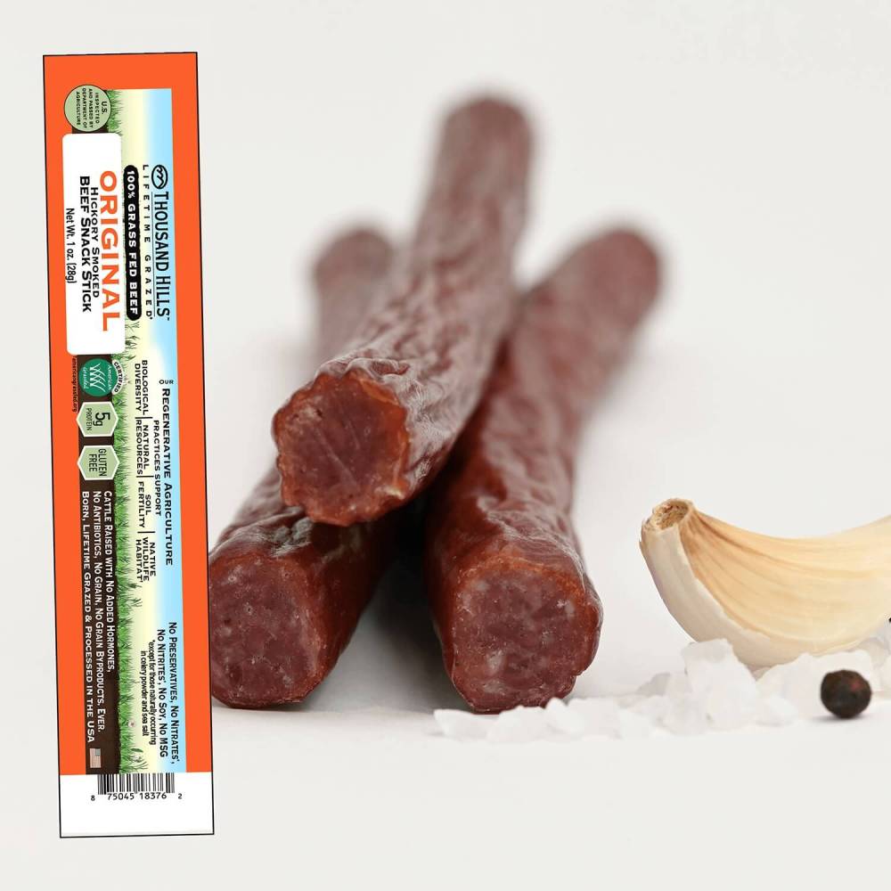 Three original beef sticks with a Thousand Hills packaging on a white background