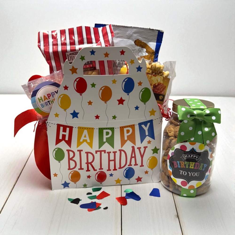 White gable box with multicolor happy birthday banner with balloons design along with birthday cookies, popcorn and snacks