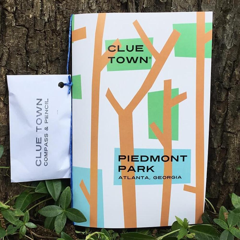 Clue Town Piedmont Park Adventure Book with tree design and includes a pouch with pencil and compass
