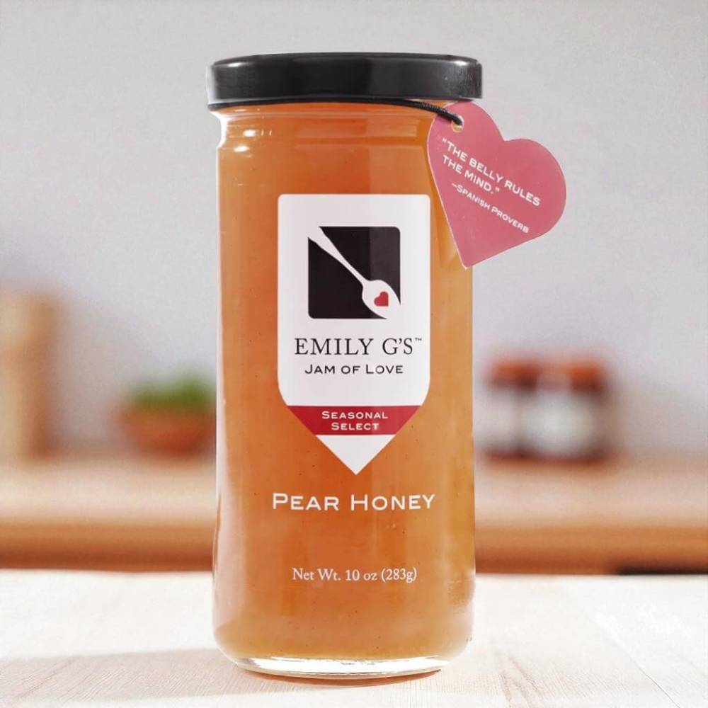 Jar of pear honey jam sitting on kitchen counter