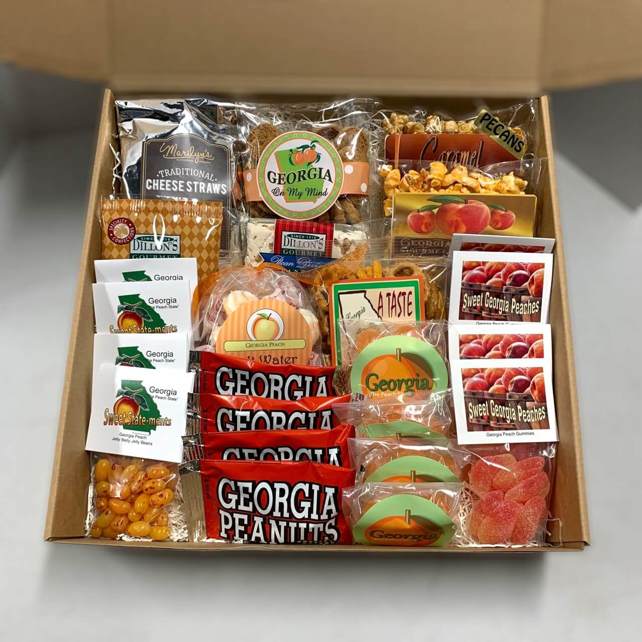 Box of Georgia-themed snacks and treats on a white background