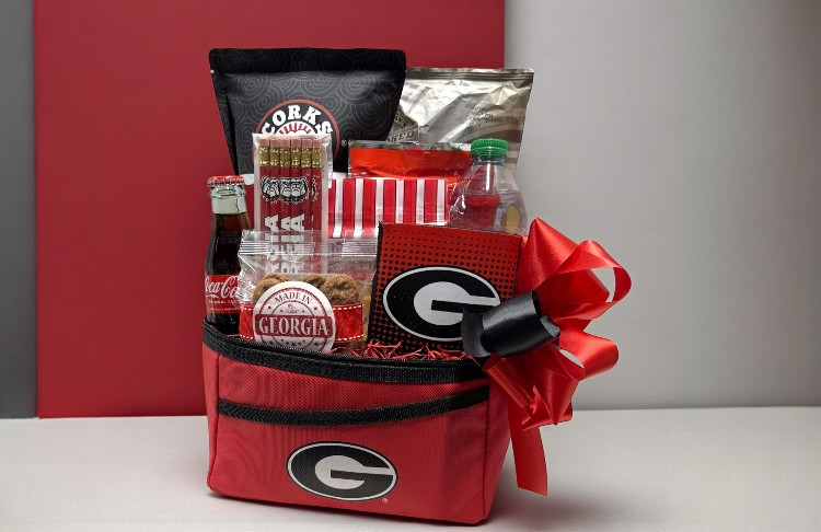 Gift basket with snacks and Georgia Bulldogs theme merchandise on a neutral background