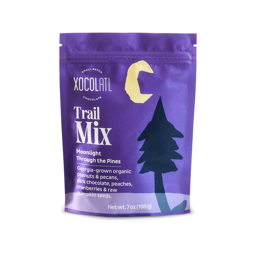 Purple Xocolat trail mix package with tree design on a white background