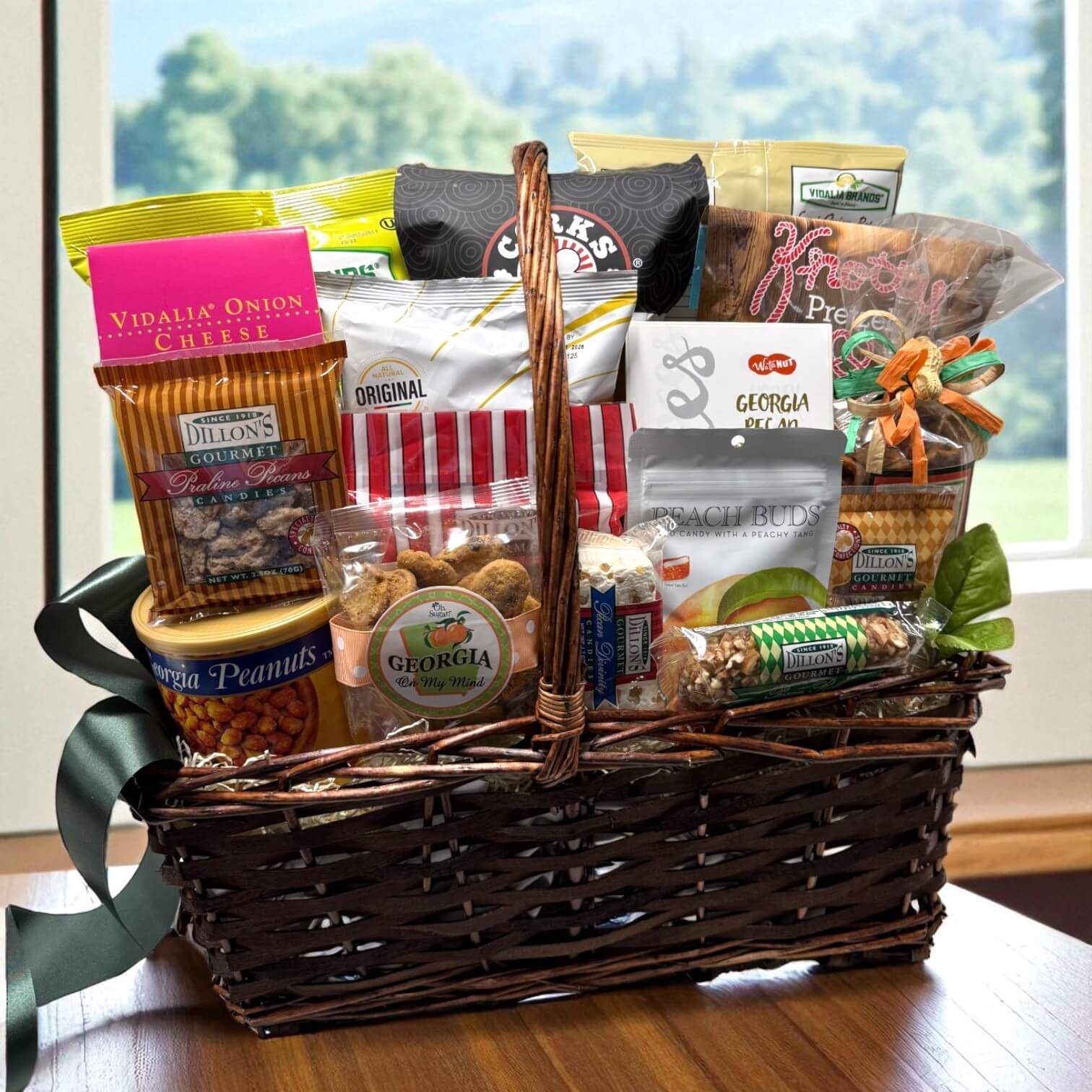 Georgia gift basket with various snacks and treats on a wooden table.