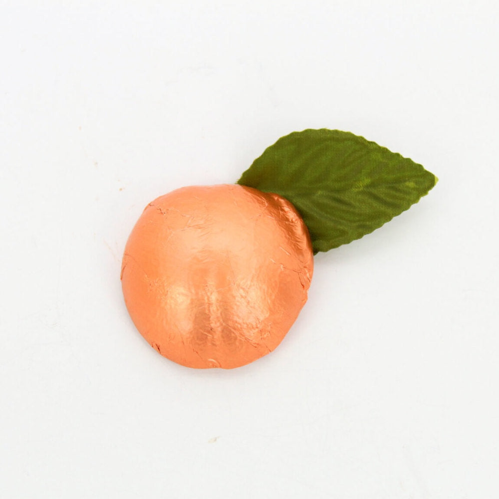 Chocolate shaped peach wrapped in peach colored foil with leaf accent