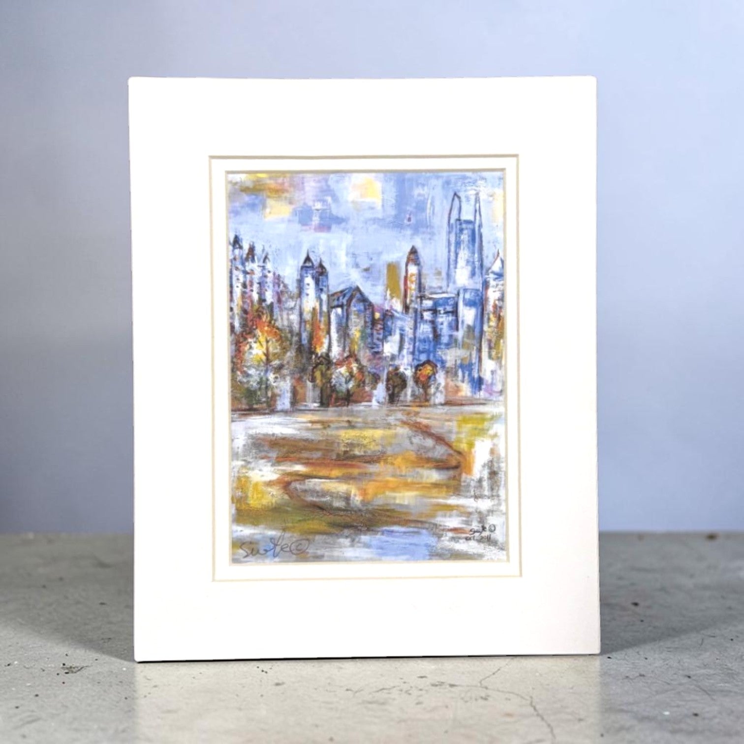 Framed abstract Atlanta cityscape painting on a plain background