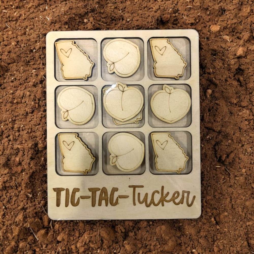 Tic-Tac-Toe game set with Georgia and peach designs for Tucker on a brown surface