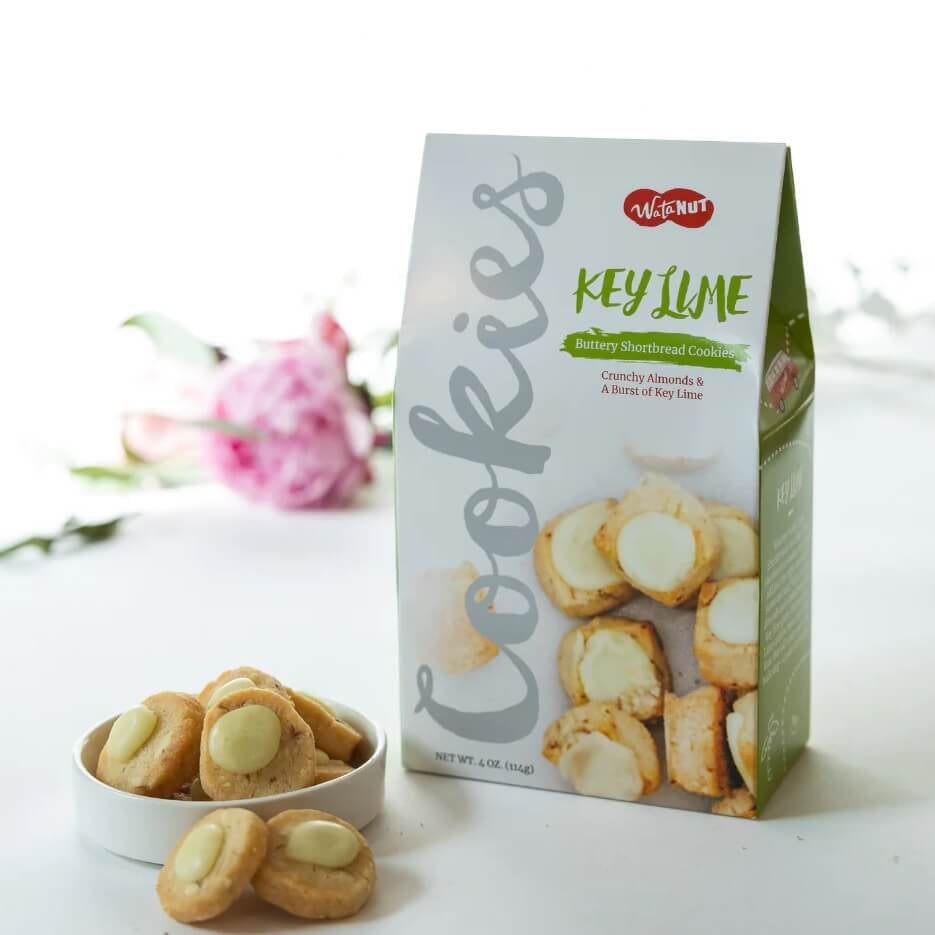 Key lime cookies with a box of cookies on a white background