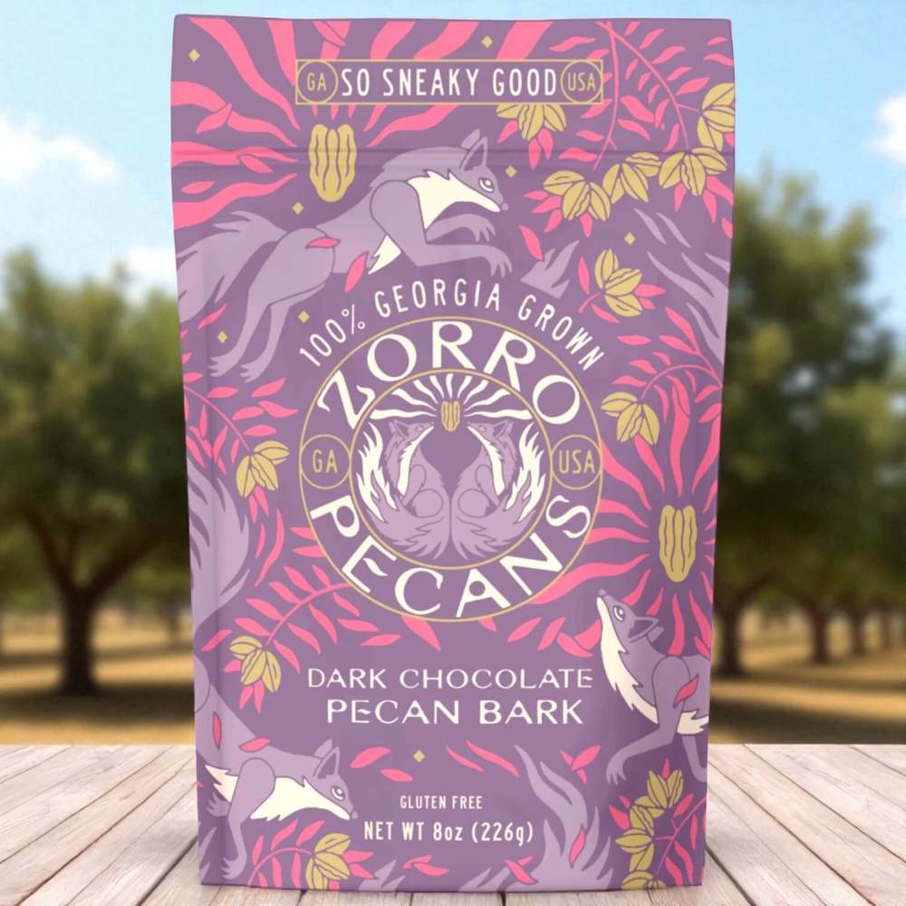 Dark chocolate pecan bark in purple resealable pouch sitting on a table
