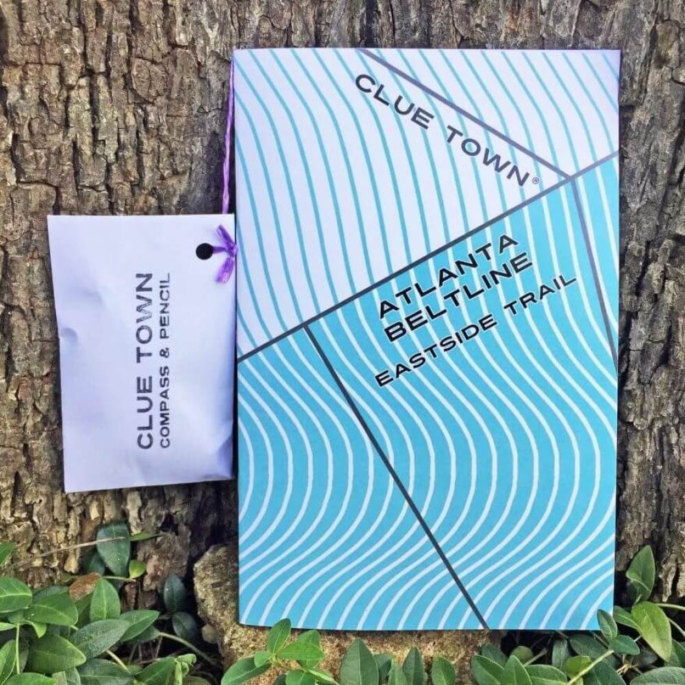 Blue and white striped Clue town Atlanta Beltline Eastside Adventure Book with pouch that contains pencil and compass