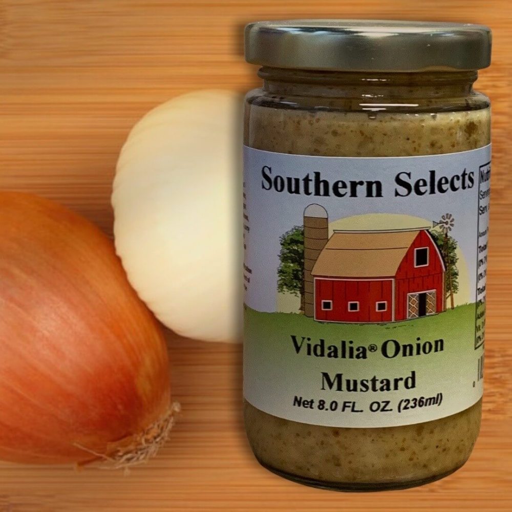 Vidalia Onion Mustard from Georgia in a 8 ounce glass jar with onions in the background.