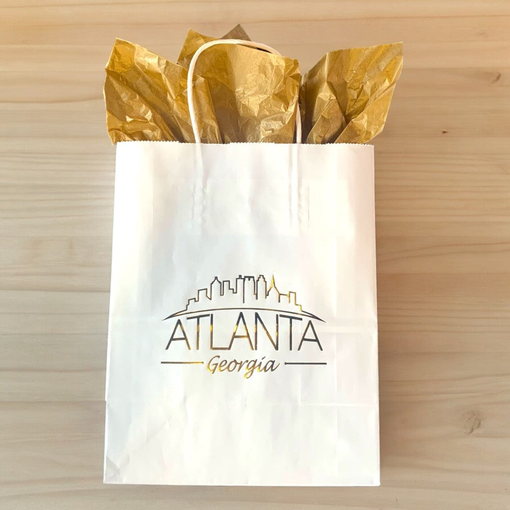 White gift bag with Atlanta skyline imprint in gold foil