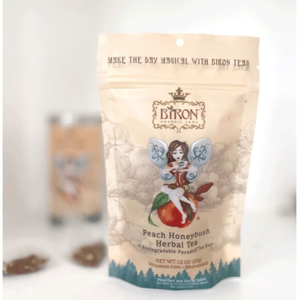 Pouch of Biron Peach Honeybush Herbal Tea with fairy design and pyramid tea bags