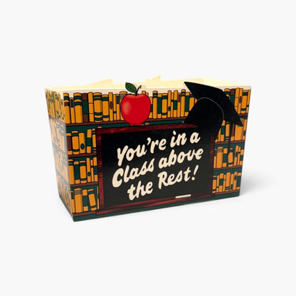 A novelty book box with a graduation theme, featuring a black front panel with the text &