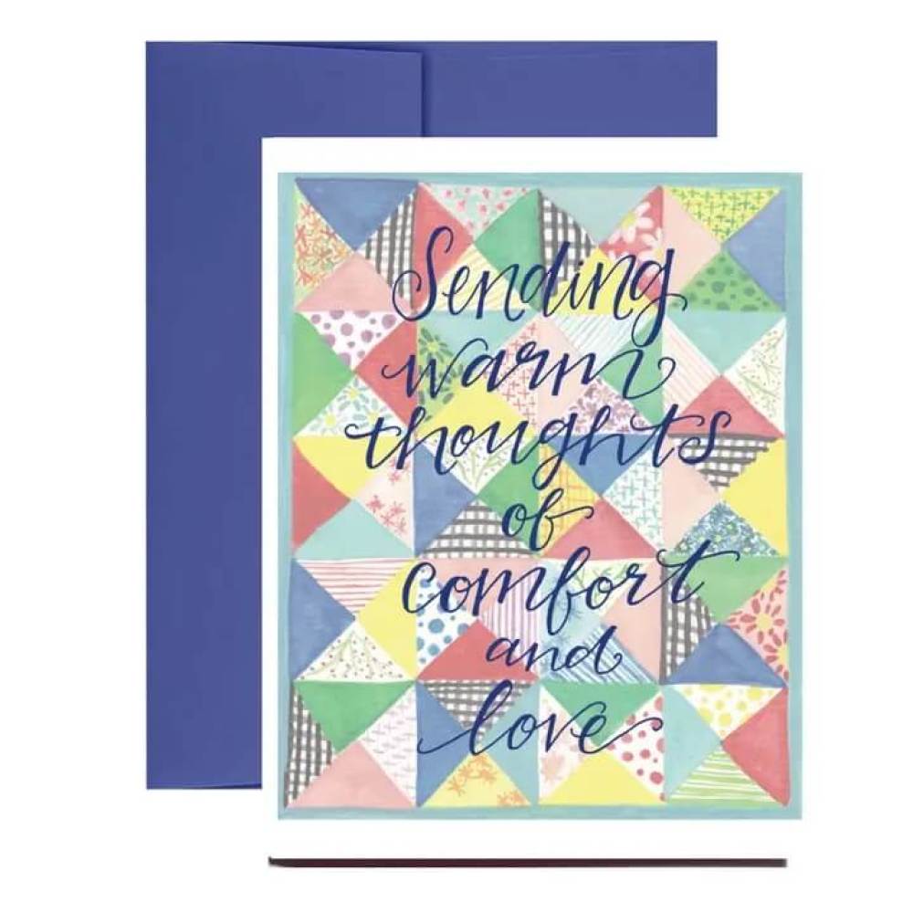Colorful quilt design is the background for the words of comfort on the front