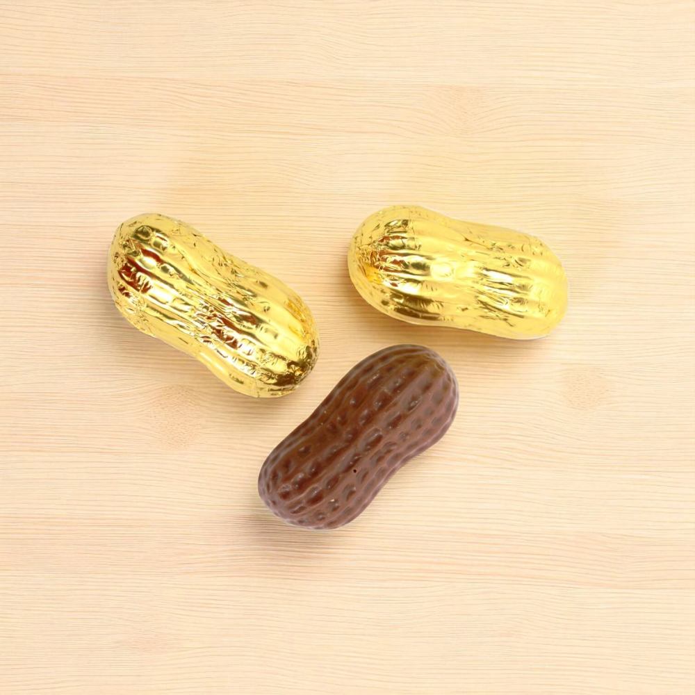 Three chocolate shaped peanuts wrapped in gold foil