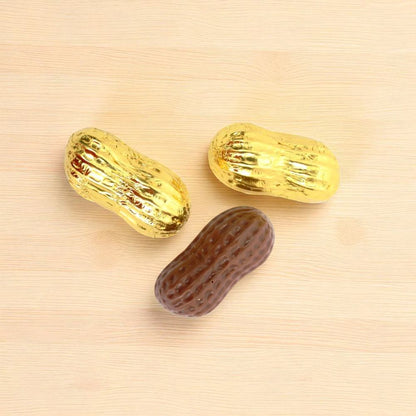 Three chocolate shaped peanuts wrapped in gold foil
