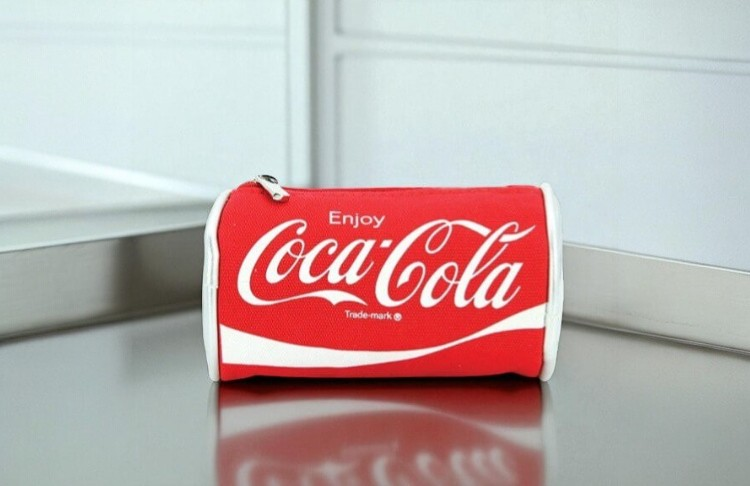 Coca-Cola can-shaped coin purse on a neutral background