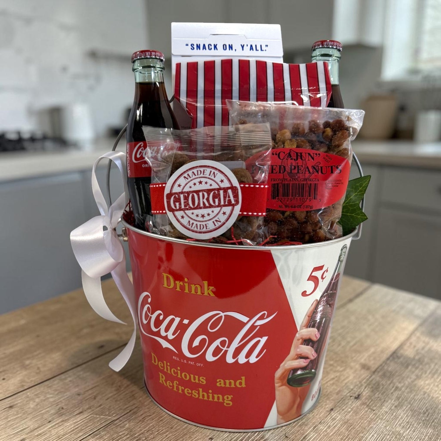 Coca-Cola gift basket with snacks and drinks on a kitchen counter