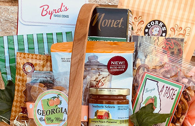 Assorted Georgia food products including cookies, preserves, and snacks in a wooden basket.