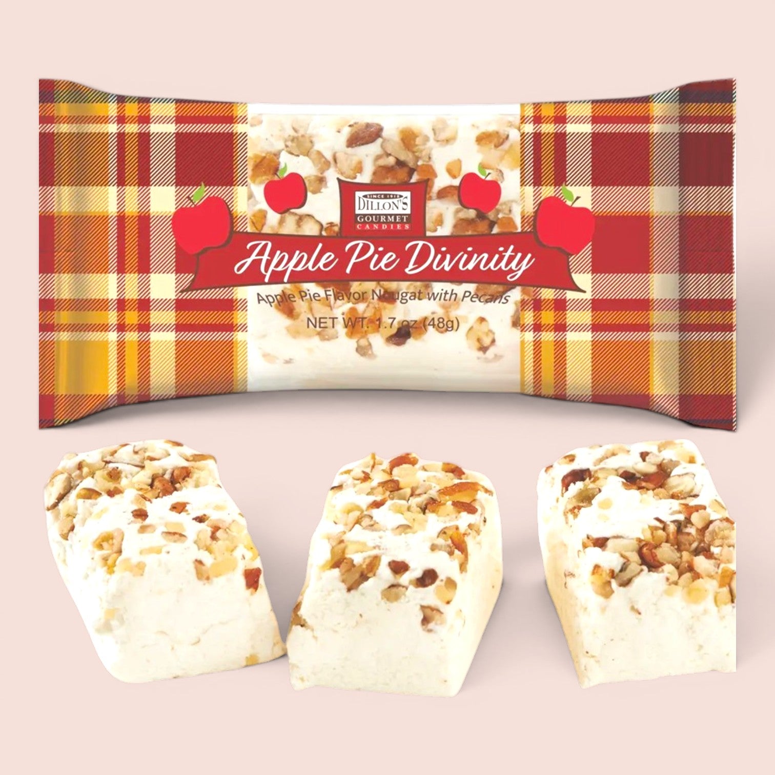 A package of Apple Pie Divinity, shown with three pieces of the dessert displayed below on a light pink background. The packaging features a red, orange, and yellow plaid pattern with illustrations of red apples and a white center showing the dessert chunks.