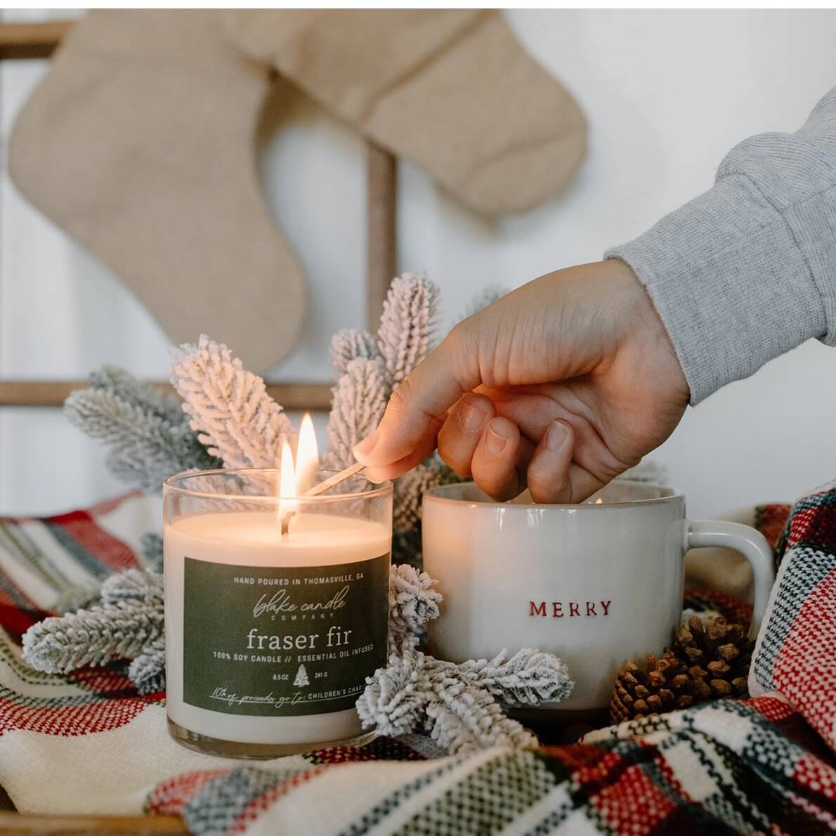 Person lighting a candle with a &