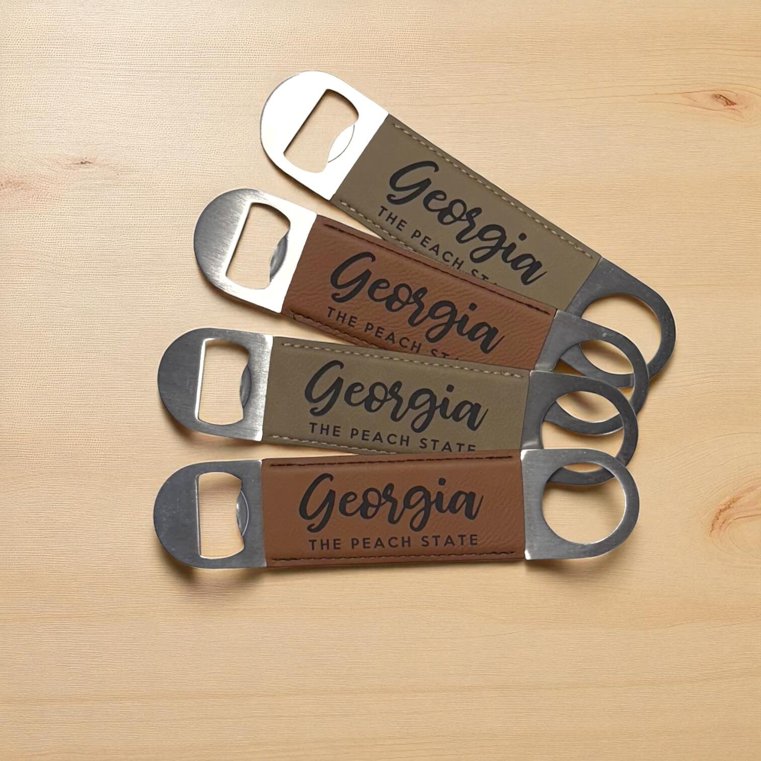Four bottle openers with leather straps and &