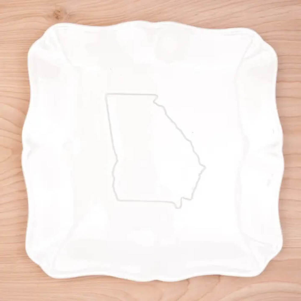 White porcelain platter with scalloped edges with raised state of Georgia in the center