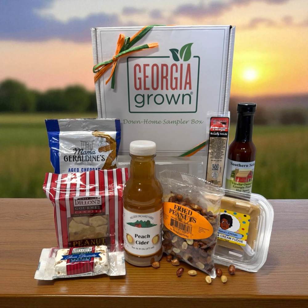 Collection of Georgia foods including peanut brittle, peach cider, divinity and more in a white gift box