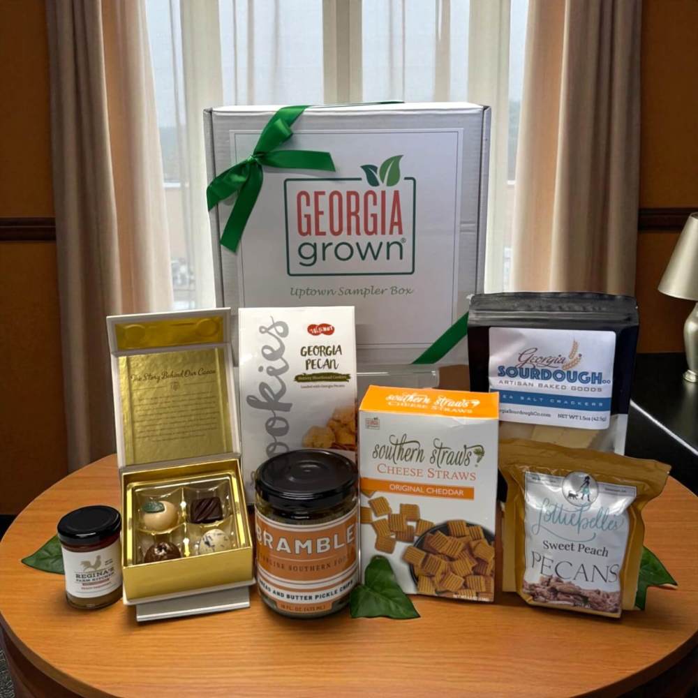 Collection of Georgia gourmet foods on a table with a white Georgia Grown gift box
