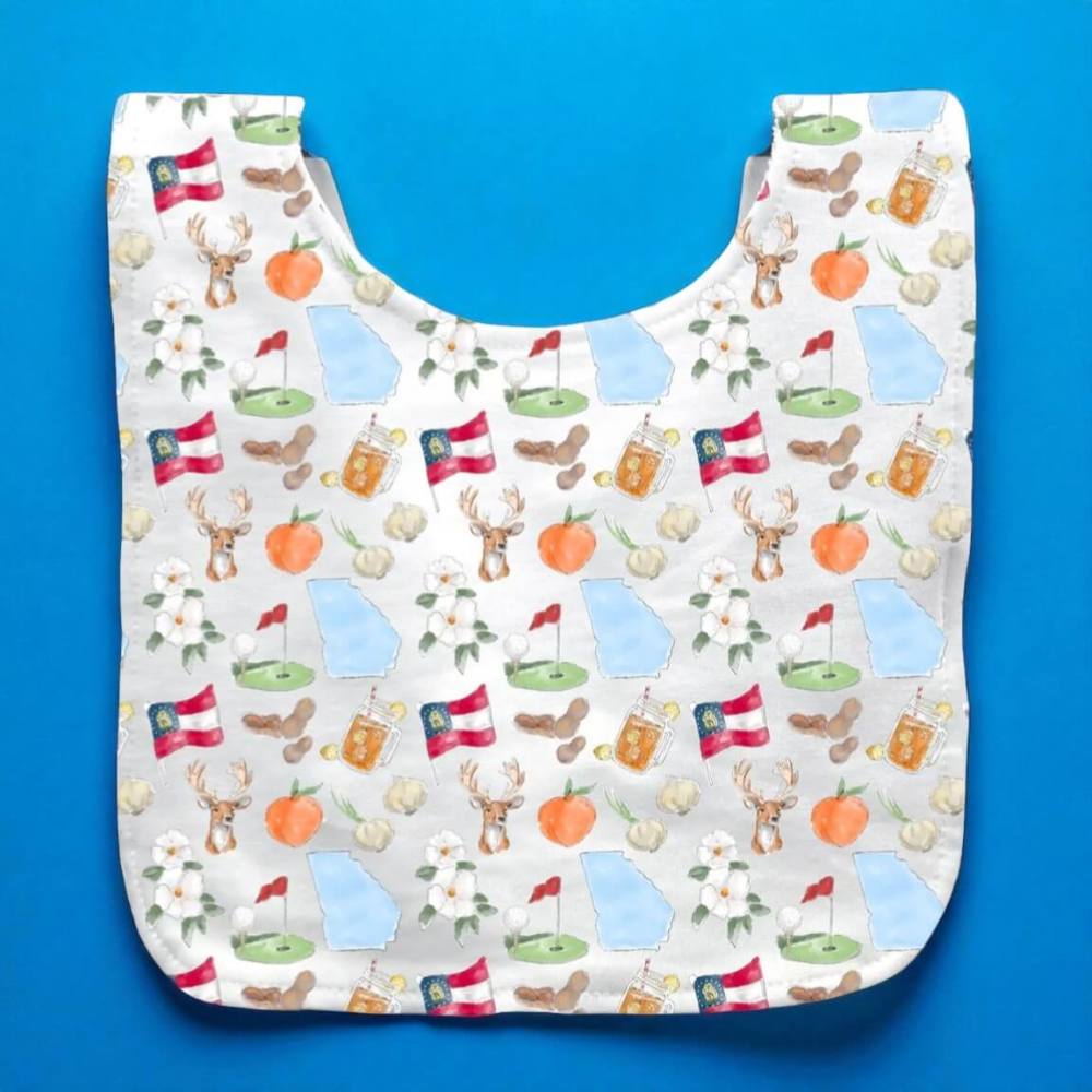 White baby bib with printed with peaches, state symbols and images iconic to Georgia