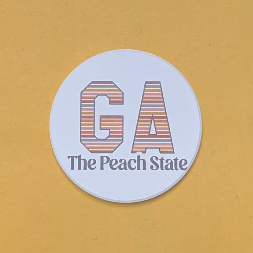 Round car coaster with striped letters for Georgia and The Peach State