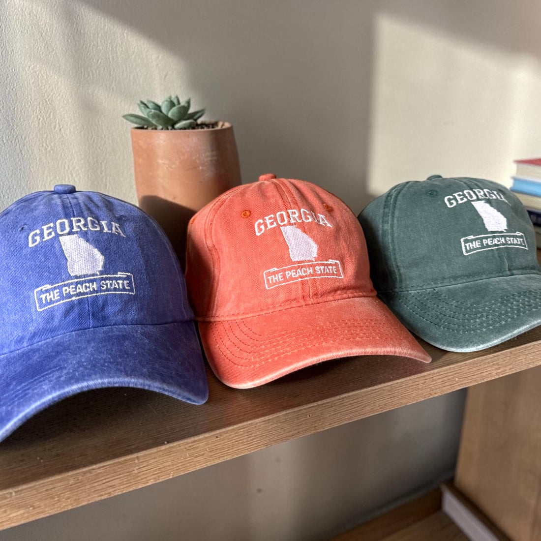 Three baseball caps with &