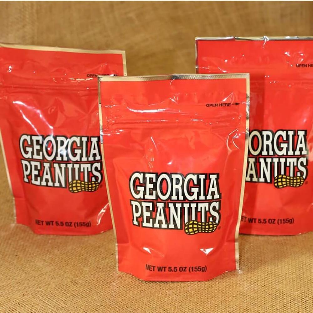 Three red resealable bags of Georgia peanuts.