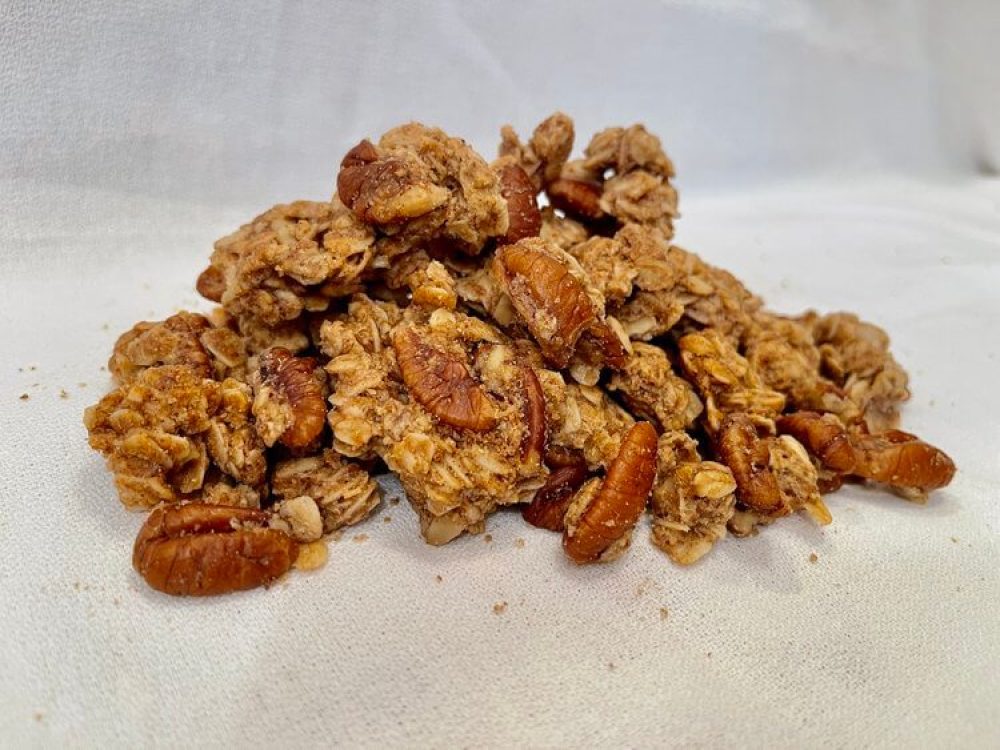 Pile of Goodson pecan granola on a white surface