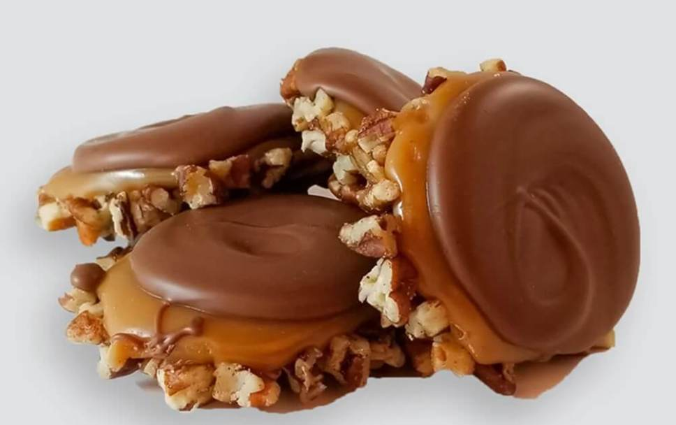 Savannah Candy Kitchen chocolate gopher turtles with caramel and nuts on a white background