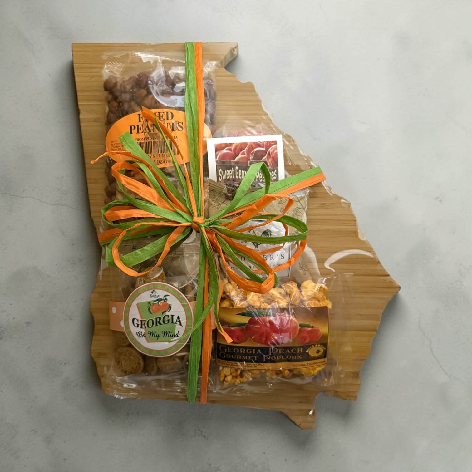 Gift set with snacks on a wooden board shaped like the state of Georgia.