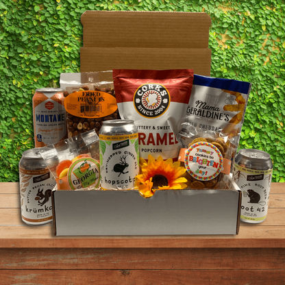 White gift box filled with a sunny selection of Georgia snacks and beverage.