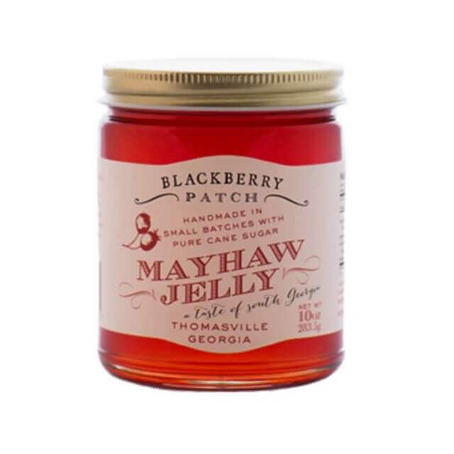 Jar of Mayhaw Jelly with a red label on a white background