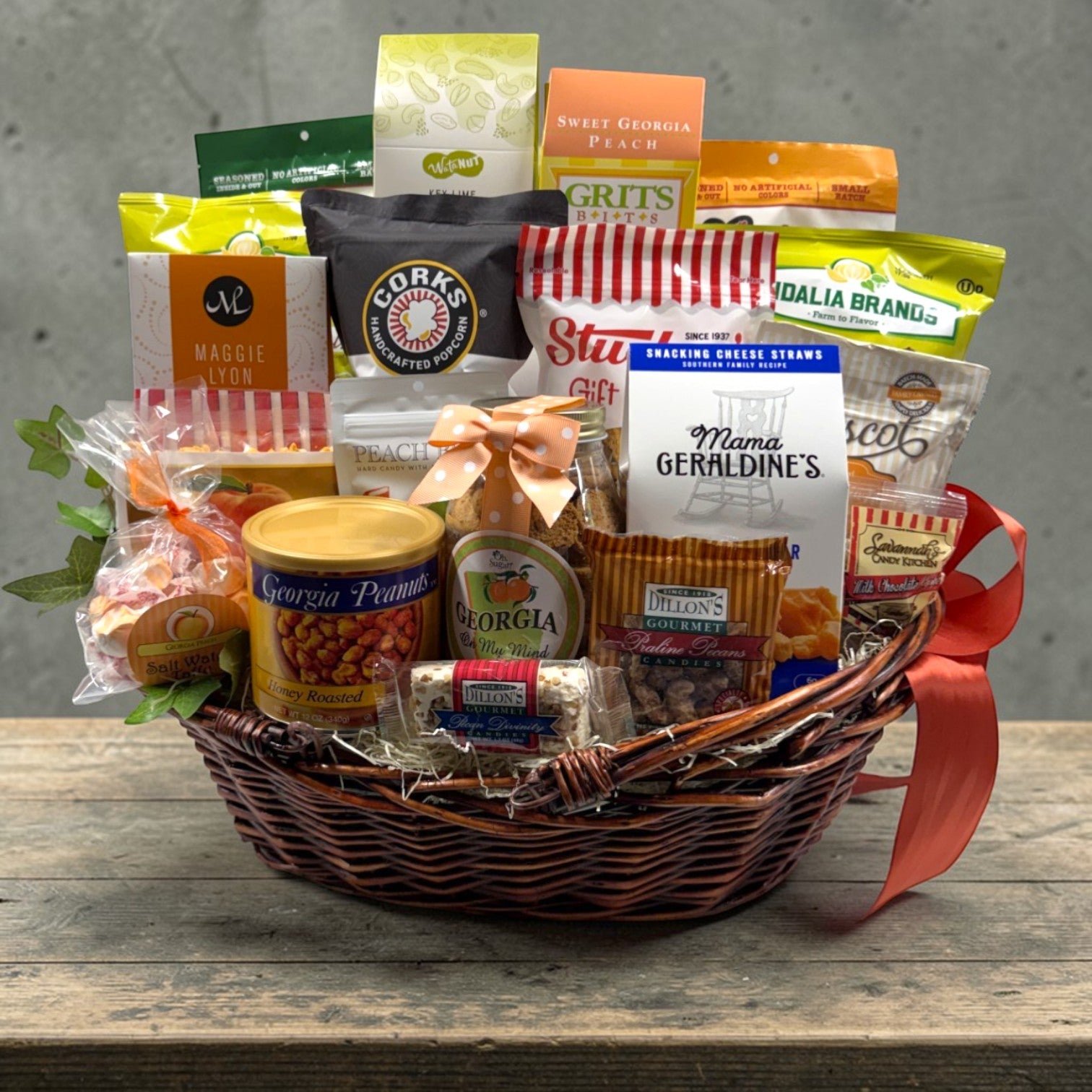 Large gift basket with various snacks and products on a wooden surface