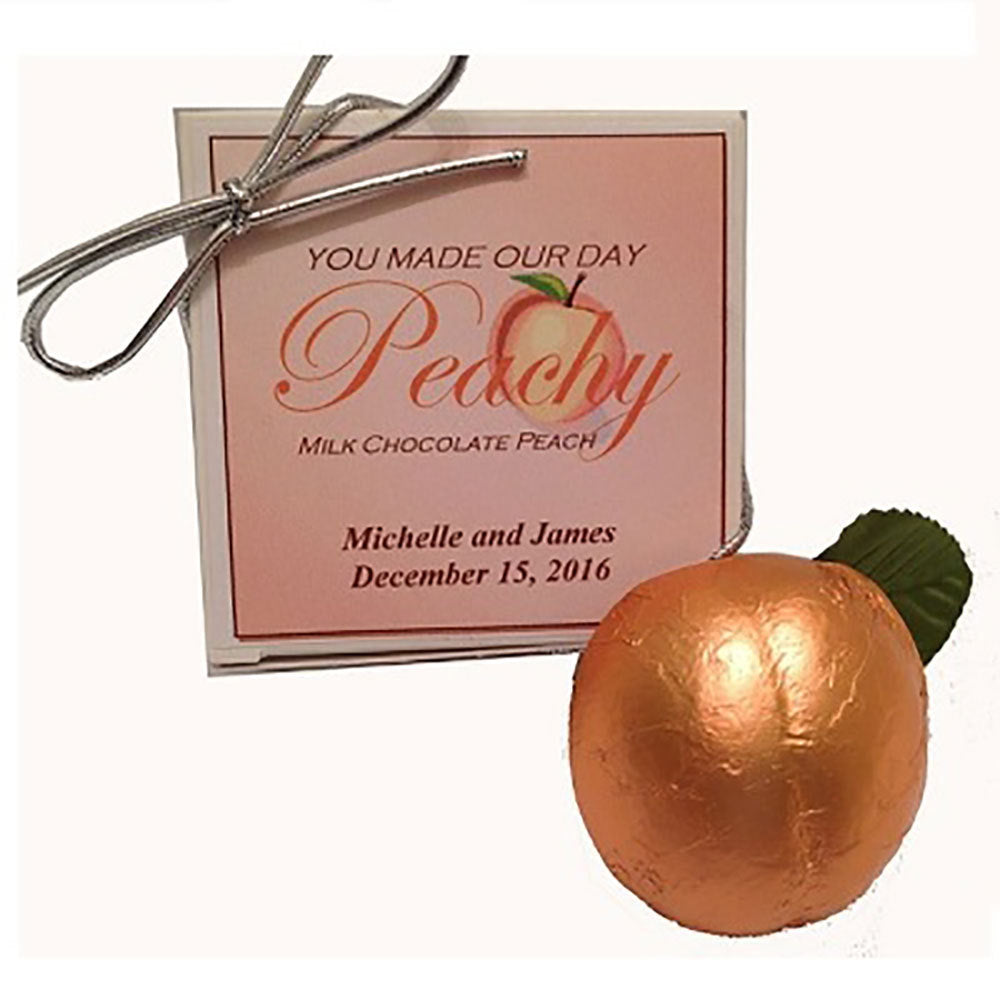 Box with a You Made Our Day label customized with name and date and peach shaped chocolate