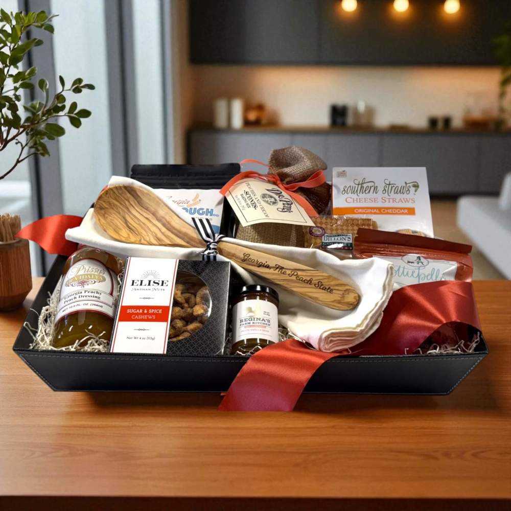 Black tray carries an artisan selection of Georgia foods with engraved wooden spoon and towel set