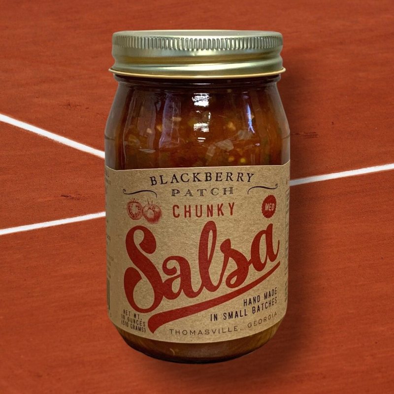 Jar of Blackberry Patch Chunky Salsa on a wooden surface