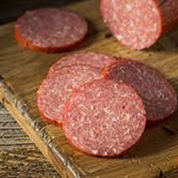 Sliced pieces of Striplings Sausage on wood cutting board