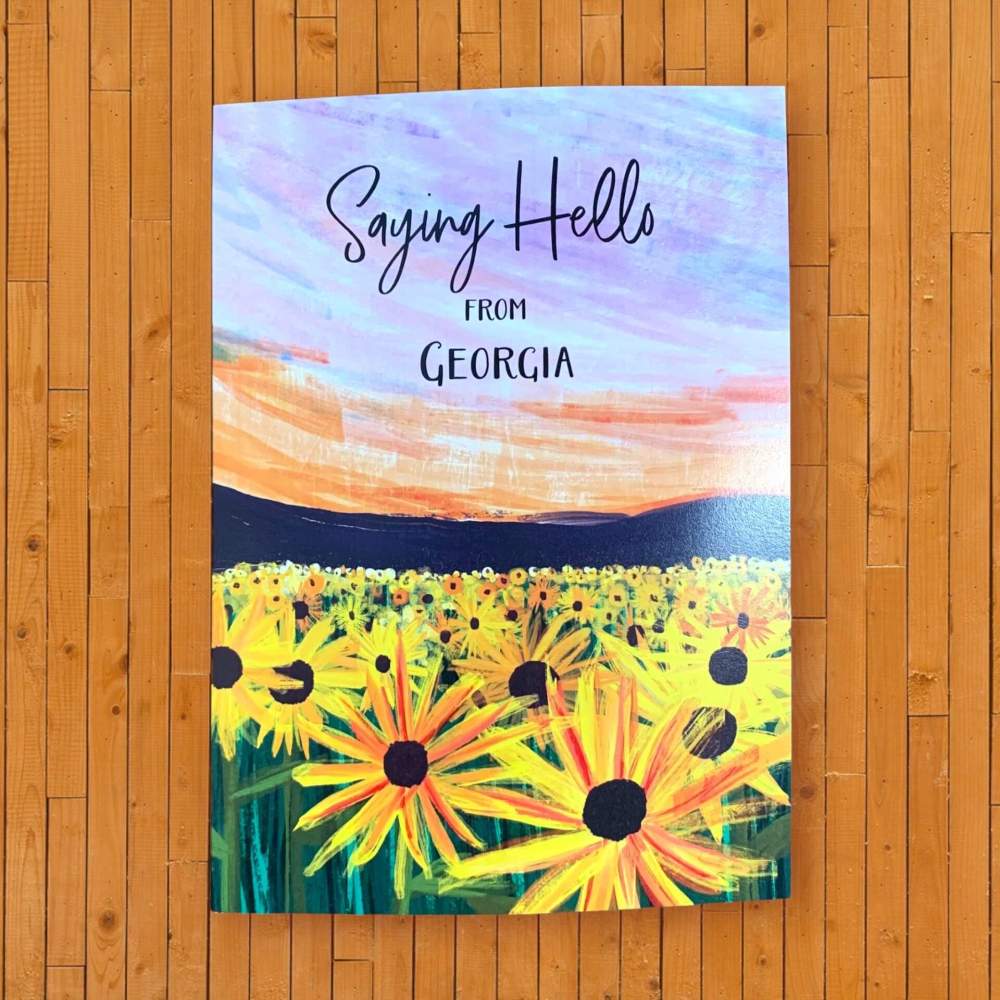 Georgia greeting card with yellow flowers in a field reads Saying Hello From Georgia