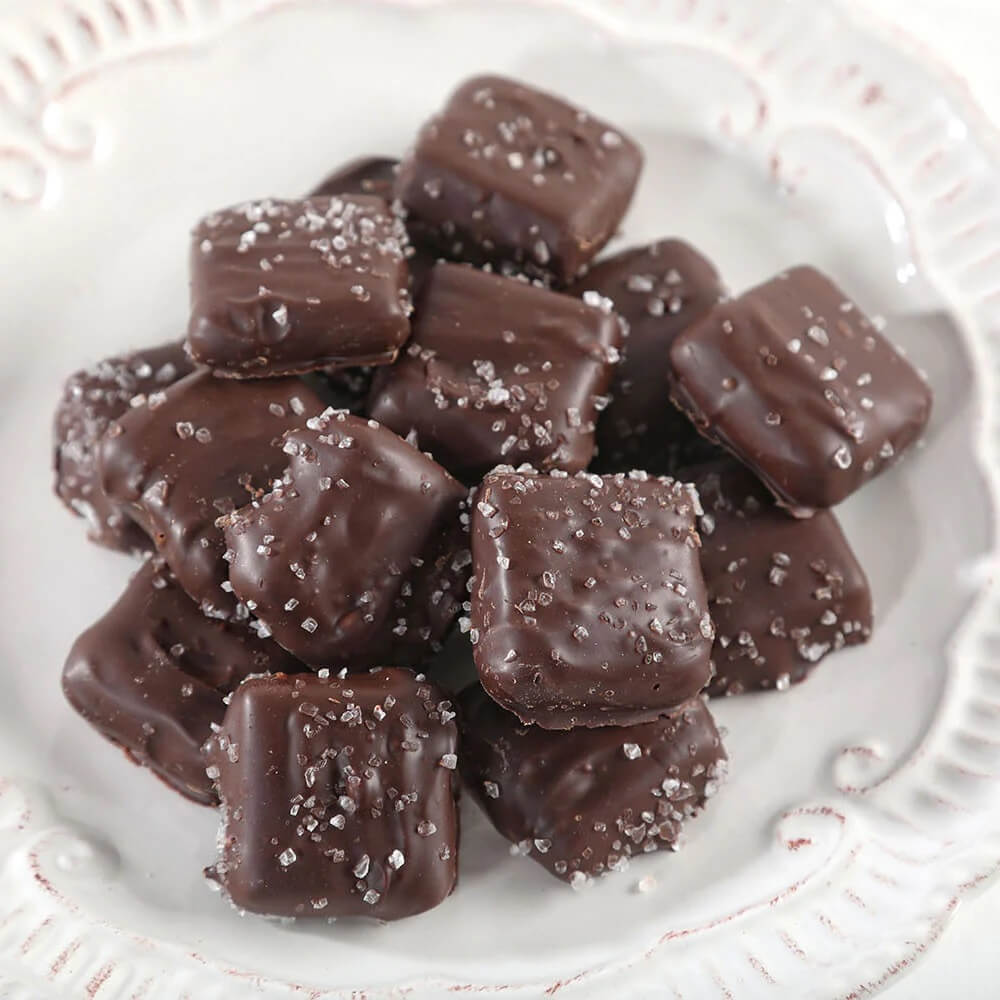 Group of sea salt caramels candies displayed on white plate