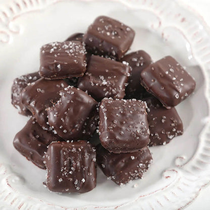 Group of sea salt caramels candies displayed on white plate