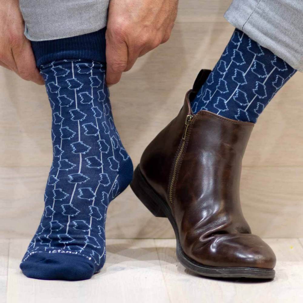 Navy blue crew length socks with the State of Georgia outline repeated throughout.