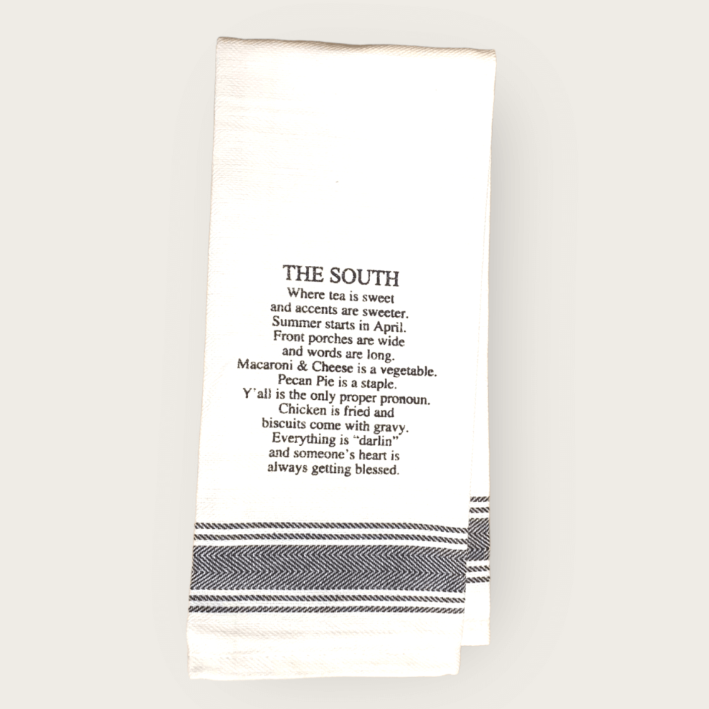 White tea towel with black printing about life in the South.